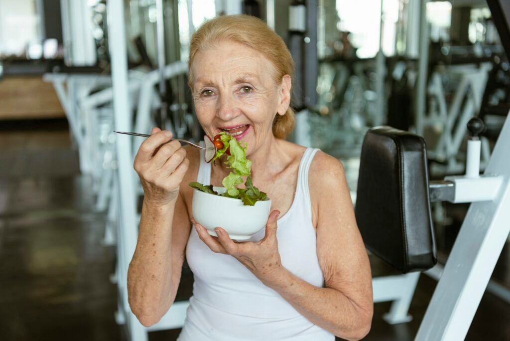 Senior woman eating healthy salad. elderly health lifestyle nutrition concept.